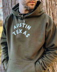 man wearing everyday hoodie with austin print in white and green